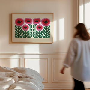 May include: A framed print of a stylized floral design featuring pink and red flowers with green leaves on a white background.