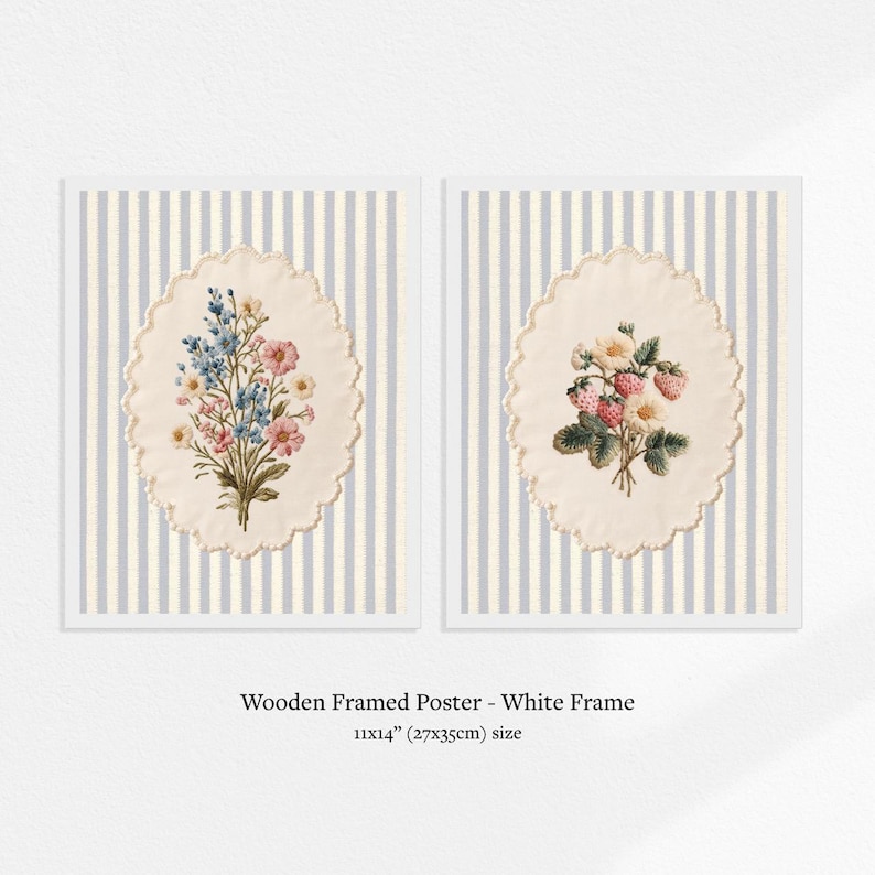 May include: Two framed posters with white frames. Each poster features a floral design within an oval, scalloped border. The background is a striped pattern of white and light blue. The text at the bottom reads: Wooden Framed Poster - White Frame 11x14" (27x35cm) size.