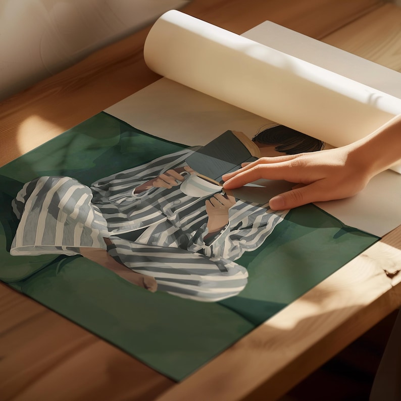 May include: An illustration of a person in striped pajamas, holding a book and a white coffee cup. The person is sitting on a green surface. The image is partially covered by a rolled-up piece of paper.