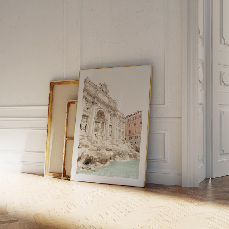 May include: A framed photograph of the Trevi Fountain in Rome, Italy. The fountain is a popular tourist destination and is known for its beautiful architecture and cascading water.