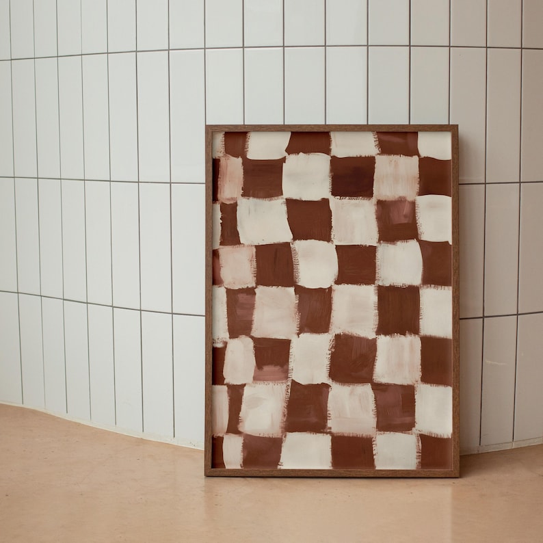 May include: A framed abstract painting with a checkered pattern in shades of brown and white.