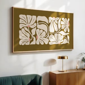 May include: A framed print with a mustard yellow background and a white floral design. The flowers are stylized and have pink centers.
