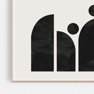 May include: Black and white abstract art print with geometric shapes in the form of a word. The print features a rounded rectangle, a circle, and a half-circle.