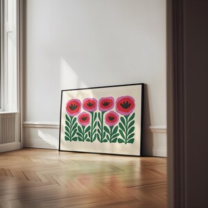 May include: A framed print of a stylized floral design featuring pink and red flowers with green leaves on a cream background.