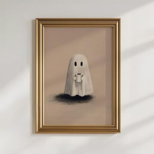 May include: Framed art print featuring a whimsical ghost holding a coffee cup. The ghost is depicted in a simple, cartoonish style with a white sheet and black eyes. The artwork is set against a neutral background, framed in gold.