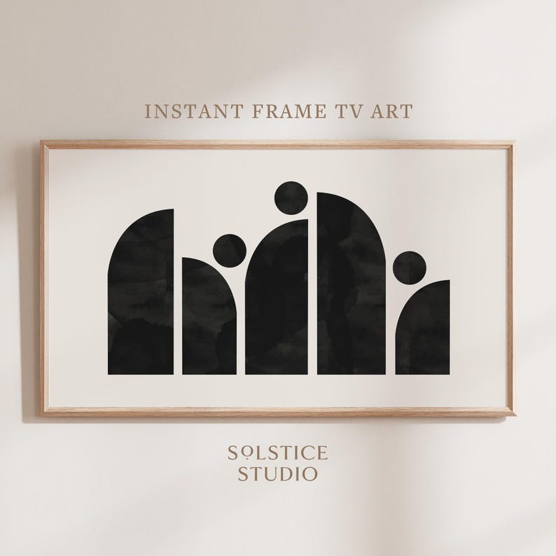 May include: Black and white abstract art print with geometric shapes in the form of arches and circles. The print is framed in a light wood frame. The text "INSTANT FRAME TV ART" and "SOLSTICE STUDIO" is visible on the print.