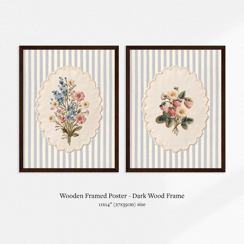 May include: Two framed floral prints. Each print features a bouquet of flowers on an oval, cream-colored background, set against a striped, light blue and white backdrop. The frames are dark wood. The size is 11x14 inches.