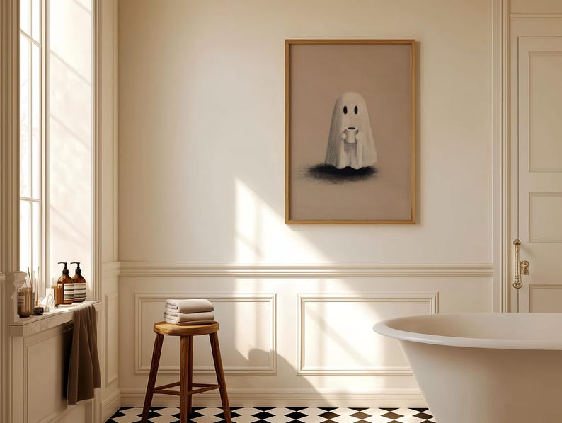 May include: A framed artwork featuring a cartoon ghost holding a small object, set in a bathroom with a wooden stool, towels, and a bathtub. The artwork is in a gold frame, and the bathroom has a black and white checkered floor.