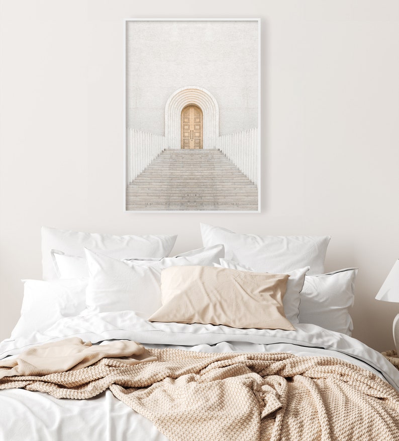 May include: A white minimalist print featuring a wooden door at the top of a set of stairs with white railings. The door is set in a white archway.
