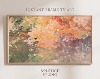 May include: Abstract painting in warm colours, featuring shades of pink, orange, yellow, and green. The painting has a textured, brushstroke effect and is framed in a light wood frame. The text "INSTANT FRAME TV ART" and "SOLSTICE STUDIO" is visible below the painting.