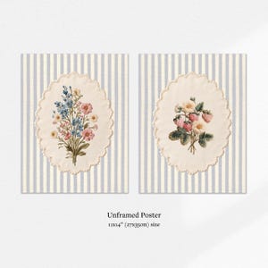 May include: Two unframed posters, each featuring a floral bouquet within an oval, scalloped frame. One bouquet has blue and pink flowers, the other has strawberries. The background is striped in light blue and white. The posters are 11x14 inches.