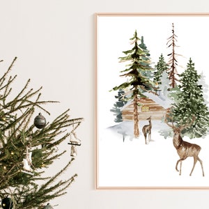May include: Watercolor painting of a winter scene with a cabin, evergreen trees, and deer. The artwork is framed in a gold-colored frame. The painting evokes a sense of peace and tranquility, perfect for holiday decor.