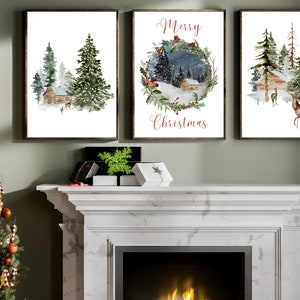 May include: Three framed watercolor prints depicting winter scenes. One shows a cabin in a snowy forest, another features a wreath with the text "Merry Christmas," and the third displays a cabin and deer. The frames are dark brown.