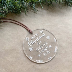 May include: Clear round Christmas ornament with the text "Our 1st Christmas as a Forever Family 2020" and the names Jeff, Audrey, Erin, Teagan, and Ben.