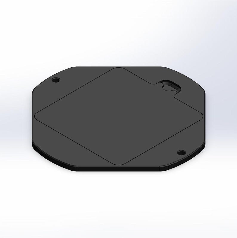 May include: A black octagonal plastic plate with a square cutout in the centre. The plate has two small holes on the top and bottom edges.