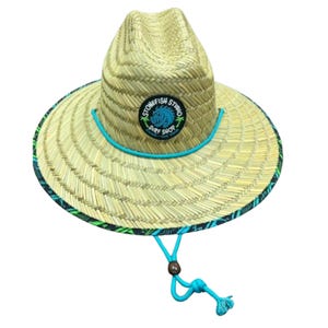 May include: A straw hat with a wide brim, featuring a turquoise chin strap and a patch that reads "STONEFISH STUDIO SURF SHOP". The brim has a patterned border with green and black accents. The hat is designed for sun protection.