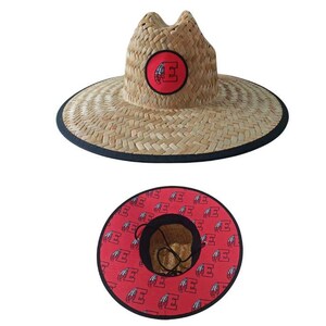 May include: A straw sun hat with a wide brim and a black trim. The hat features a red circular patch with a white letter "E" on the front. The underside of the brim is red with a repeating white "E" pattern.