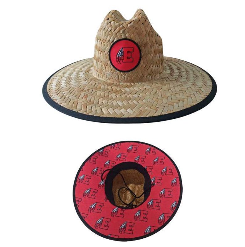 May include: A straw sun hat with a wide brim and a black trim. The hat features a red circular patch with a white letter "E" on the front. The underside of the brim is red with a repeating white "E" pattern.