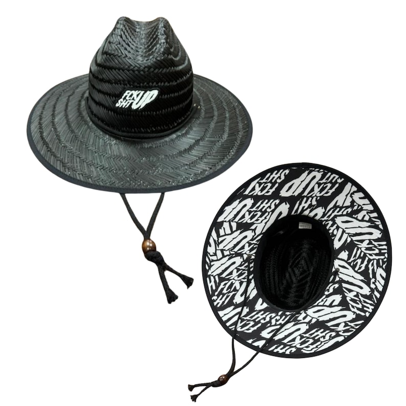 May include: Black straw hat with a wide brim and a chin strap. The hat features the text "F*CK SH*T UP" in white on the crown. The underside of the brim is white with the same text in black.
