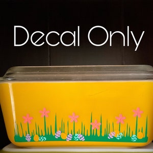 May include: Yellow glass baking dish with a decal of green grass, pink flowers, and blue and white Easter eggs. The decal reads "Decal Only".
