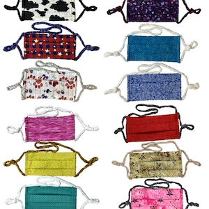 May include: A collection of 10 fabric face masks with various patterns and colors. The masks have adjustable straps and are made of cotton.