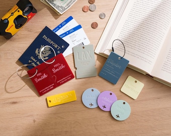 May include: A collection of personalized luggage tags in various shapes and colors, including red rectangular tags with Mr. and Mrs. Smith, a grey rectangular tag labeled LAX, a blue tag, a yellow tag, and circular tags in blue, purple, and light green.