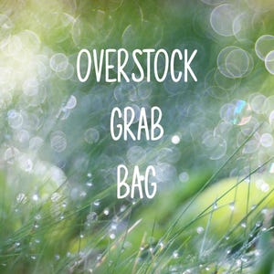 May include: A blurred background of green grass and bokeh lights with the words "OVERSTOCK GRAB BAG" in white script. The image has a soft, dreamy quality.