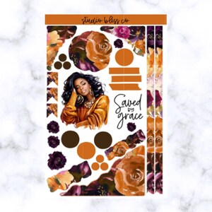 May include: A sticker sheet featuring a woman with dark hair and gold jewelry, wearing a gold top. The sheet includes floral designs in shades of orange, brown, and purple, with the words "Saved by grace".