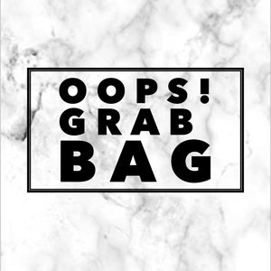 May include: Black and white text on a white marble background that reads "Oops! Grab Bag".
