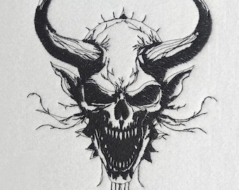 May include: Black and white embroidered skull design with large curved horns, sharp teeth, and thorny details. The skull has a menacing expression, with intricate line work. The design is on a white background, creating a striking contrast.