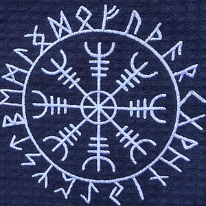 May include: White embroidered Viking symbol, the Helm of Awe, on a dark blue textured background. The symbol is a circular design with runic characters radiating outwards from a central point, creating a symmetrical pattern.