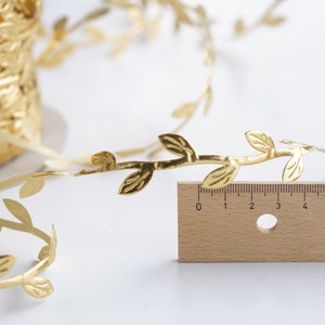May include: Gold leaf garland with leaves and branches. The garland is 6 inches long.