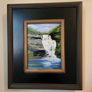 A breathtaking waterfall landscape, framed oil painting, in the NC mountains with a trout pool at its base.
