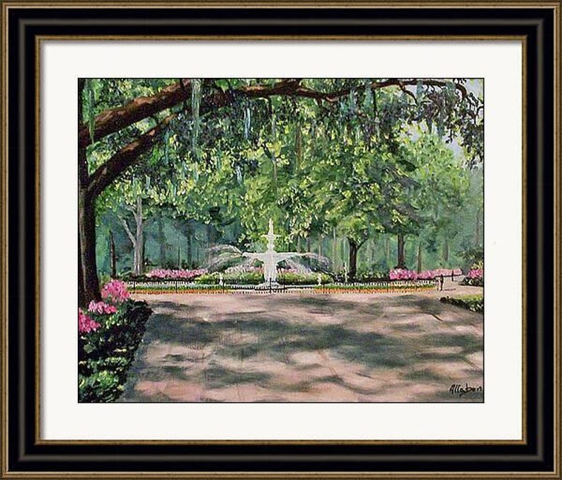 May include: A framed painting of a park scene with a fountain as the focal point. The painting features lush green trees, pink flowers, and a paved pathway. The artwork is set in a black and gold frame.