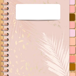 May include: A pink and white planner with a gold foil design. The planner has a white label for a name and a spiral binding.