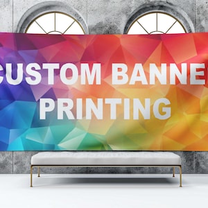 May include: A colorful banner with a geometric pattern in shades of blue, green, yellow, orange, and red. The banner has white text that reads "CUSTOM BANNER PRINTING".