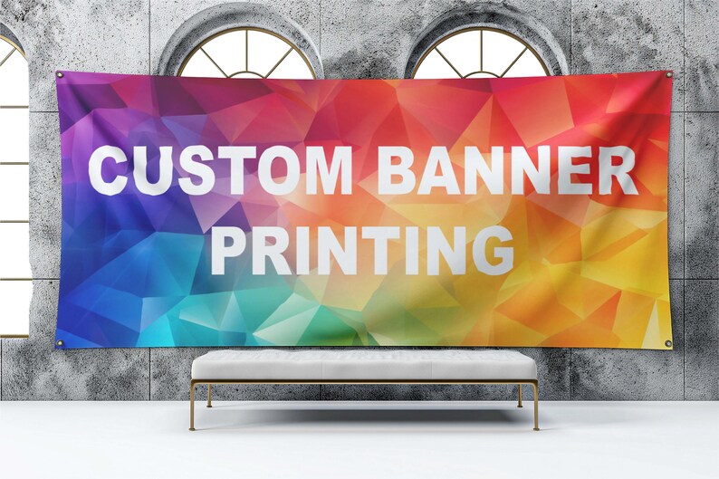 May include: A colorful banner with a geometric pattern in shades of blue, green, yellow, orange, and red. The banner has white text that reads "CUSTOM BANNER PRINTING".