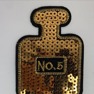Sequin perfume bottle motif