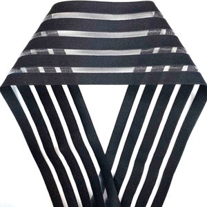 May include: Black elastic trim with white stripes. The trim has a mesh-like texture.