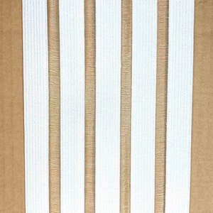 May include: White elastic with brown stripes. The elastic is woven and has a textured surface.