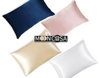 May include: Four satin pillowcases in different colours: navy blue, light pink, beige, and white. The pillowcases are arranged in a semi-circle on a white background.