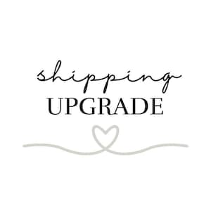 May include: Black and white text that reads "shipping upgrade" with a gray heart drawn underneath.