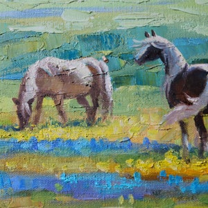 May include: An oil painting on canvas featuring two horses in a field. One horse grazes on yellow flowers while the other stands facing right. The background consists of textured, impasto brushstrokes in shades of green, blue, and yellow.