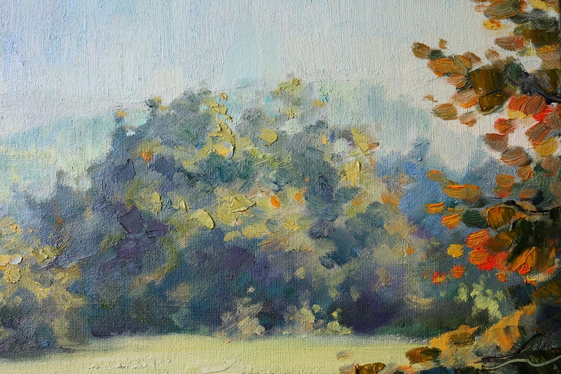 May include: An oil painting on canvas depicting a landscape with thick, textured brushstrokes. The scene features dense foliage in shades of deep blue, green, and purple, contrasted by bright orange and yellow leaves on the right side.