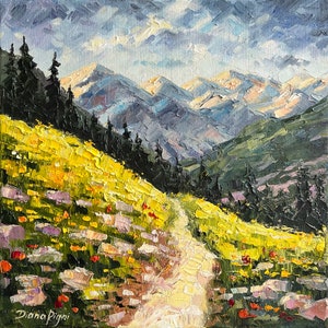 May include: An oil painting on canvas depicting a mountain landscape with a dirt path winding through a meadow of yellow wildflowers and rocks. Dark evergreen trees line the slope, and snow-capped mountains rise in the distance under a cloudy sky. The artist's signature, Diana Pigni, is visible in the bottom left corner.