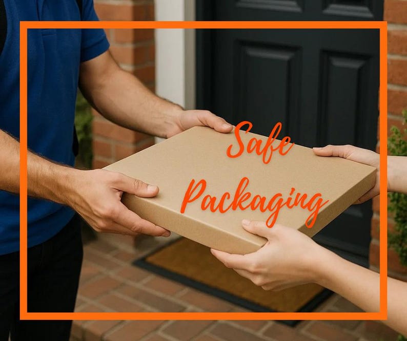 May include: A flat, square cardboard shipping box held between two sets of hands. The box is light brown with a smooth, matte surface. The text "Safe Packaging" is written in a bright orange, cursive font across the center of the box.