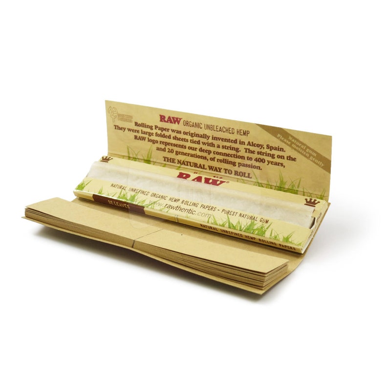 May include: Open pack of RAW Organic Unbleached Hemp rolling papers. The packaging is tan with green grass graphics and text. The text includes "RAW ORGANIC UNBLEACHED HEMP" and "THE NATURAL WAY TO ROLL". The pack contains rolling papers.