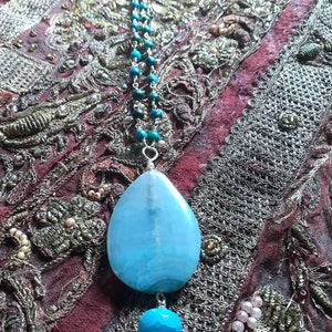 Gorgeous sea and sky blue polished quartz pendant on rosary style style chain. Chrysocolla beads of greenish blue on chain.