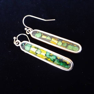 Wearable art earrings are both bold and delicate looking in shimmering color detail.