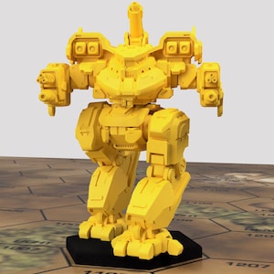 May include: A yellow plastic model of a mech robot with a large cannon on its back. The robot has two arms with guns and two legs. The robot is standing on a black base.